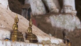 Statues in Pak Ou Cave Laos - Capture the authentic charm of Laos’s cultural scene